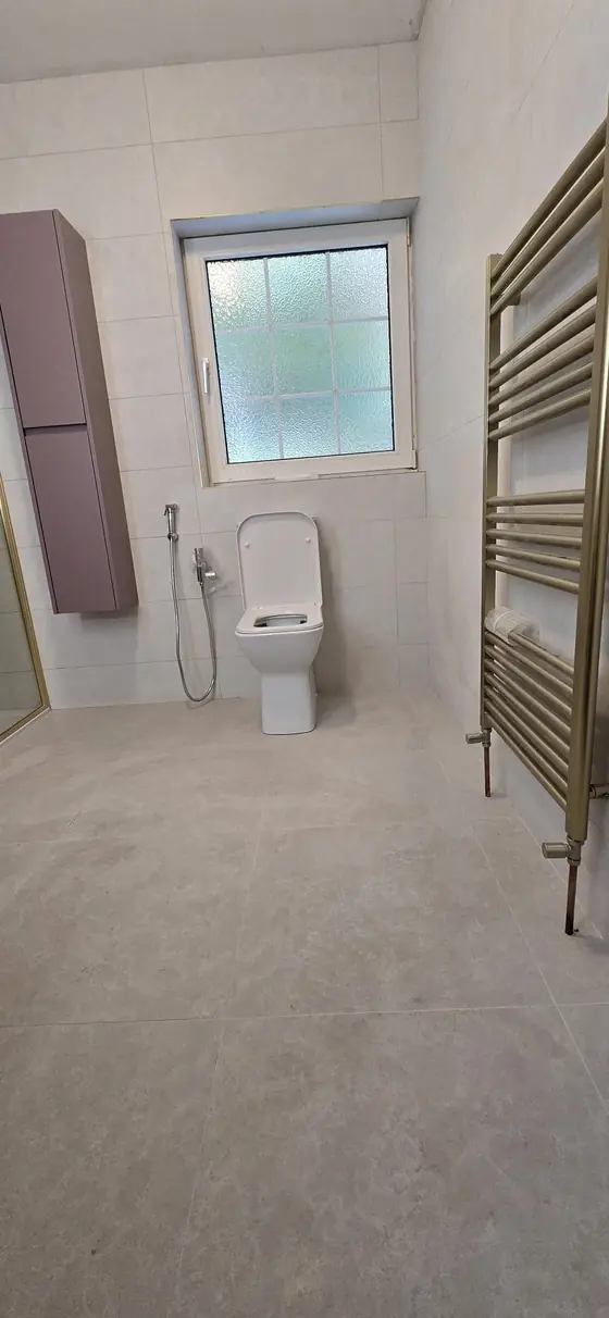 Modern bathroom with heated towel rail and tall storage unit, Bandon