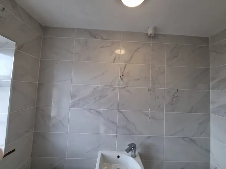 Large marble-effect wall tiles installed in a bathroom, Bandon tiler