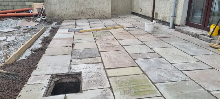 Natural stone patio laid with drainage detail beside patio doors, Cork