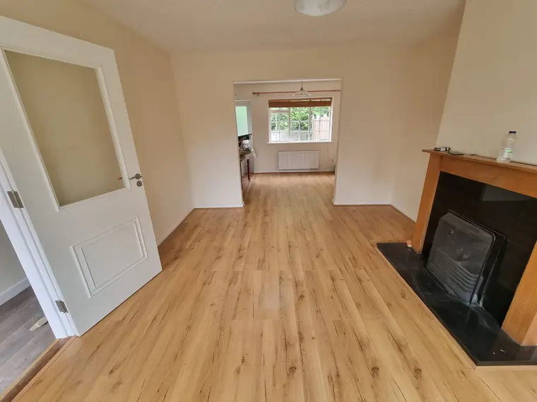 Oak-effect wood flooring fitted through a living and dining room, Bandon