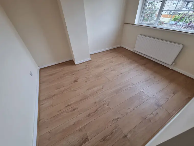 Freshly fitted wood flooring in a bright bedroom, Cork